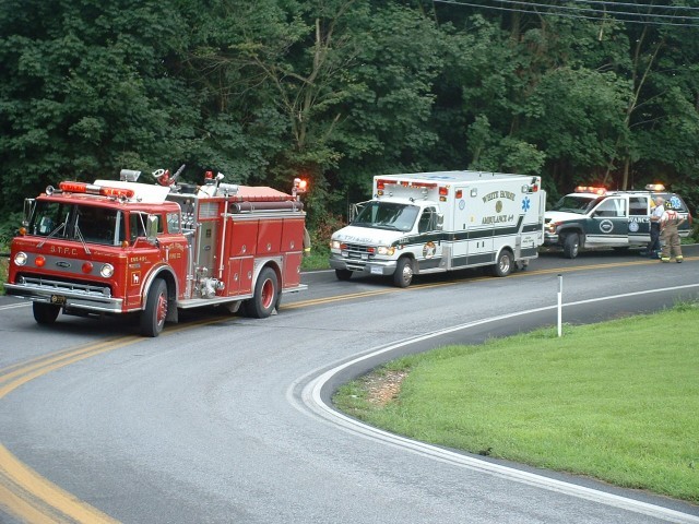 Engine 4-9-1, Ambulance 4-9, and Medic 9 at a vehicle accident, Rt.897 s-turns at Lynch Road. Car was down over the embankment in the woods behind Engine 1.... 8/9/03